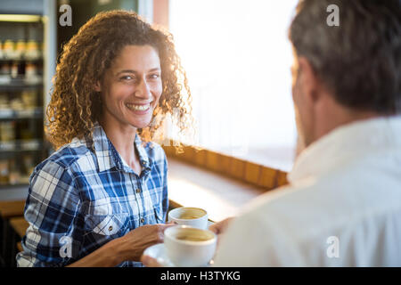 Smiling couple having coffee Stock Photo