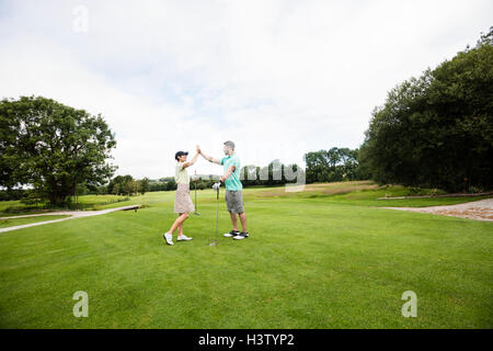 Couple giving high five to each other Stock Photo