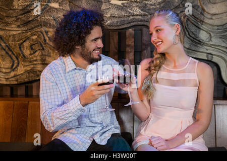 Couple toasting glass of wine in bar Stock Photo