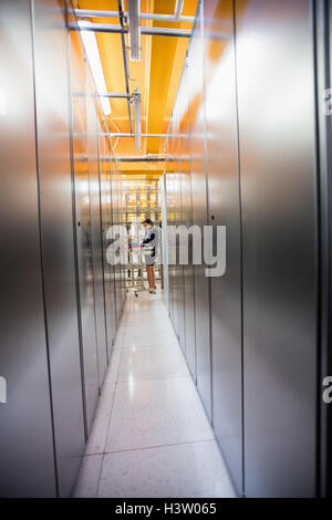 Technician working in server room Stock Photo