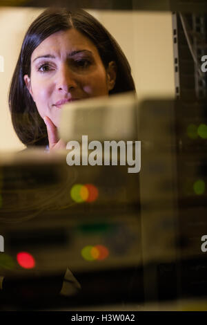 Technician working in server room Stock Photo