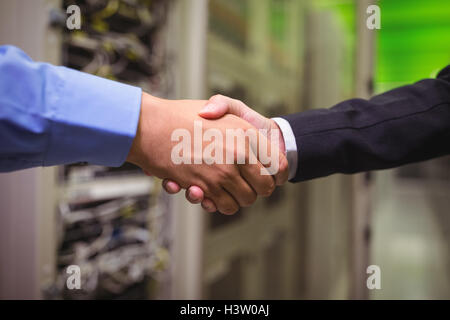 Close-up of technicians shaking hands Stock Photo