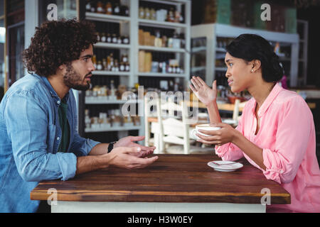 Couple interacting with each other while having coffee Stock Photo
