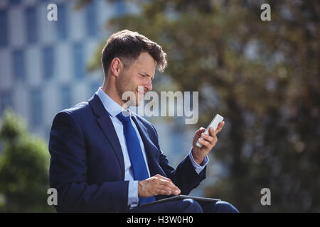 Handsome businessman using mobile phone Stock Photo