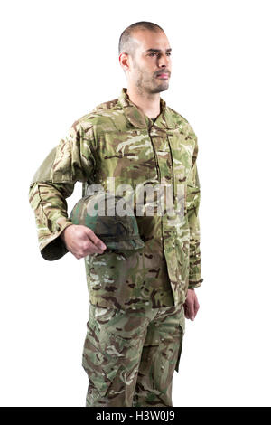 Confident soldier holding helmet while standing against black Stock ...