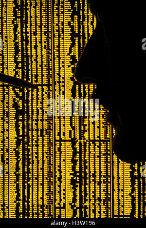 1970s ANONYMOUS SILHOUETTED MAN CHECKING LIST OF STOCK MARKET STATISTICS IN NEWSPAPER Stock Photo