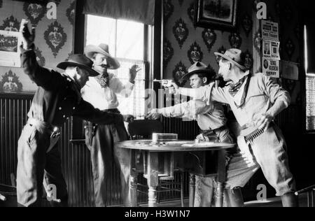 SILENT MOVIE STILL COWBOYS STOP CHEATER AT POKE TABLE GUNS DRAWN Stock Photo