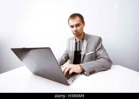 Handsome businessman works with laptop in office Stock Photo