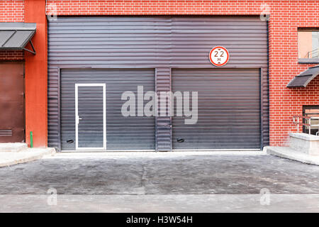 closed brown corrugated metal gate, wall of warehouse front view Stock Photo