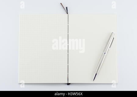 Opened notepad with pen on white background. Stock Photo