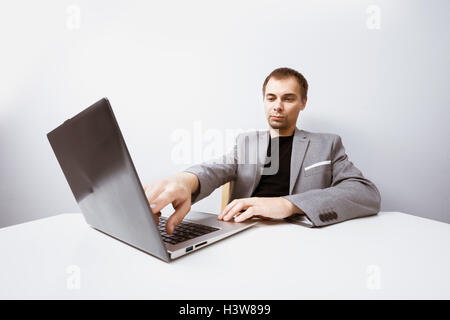 Handsome businessman working with laptop in office Stock Photo