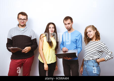 Group friends gadgets white wall Stock Photo