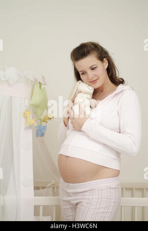 Cot, woman, pregnant, soft toy, hand, abdomen, touch, dreams away, Gestation, gestation, 25 - 35 years, pregnant, gestation, baby abdomen, touch, stroke, feel, soft animal, nestle up, dream, think, naturalness, smile, balance, happy, prejoy, child wish, f Stock Photo