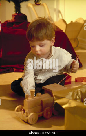 Christmas, sitting rooms, boy, Christmas present, locomotive, plays inside, at home, distribution presents, child, present, toys, railway, wooden toys, train, game Stock Photo