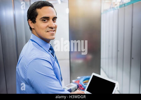 Portrait of technician working on laptop Stock Photo