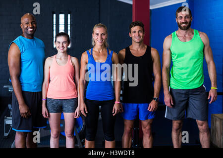 Cheerful friends standing in gym Stock Photo