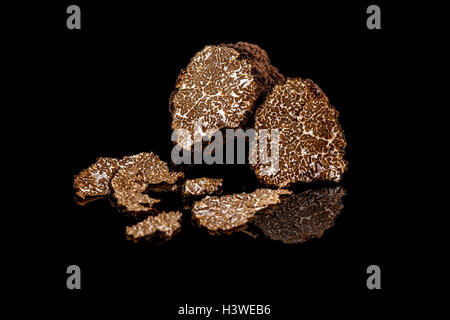 Black truffles mushrooms on black background Stock Photo