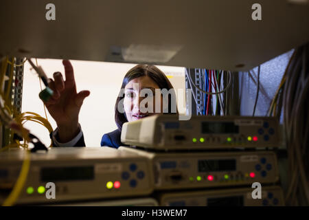 Technician working in server room Stock Photo