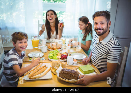 Happy family having breakfast together Stock Photo
