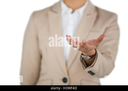 Businesswoman using digital screen against white background Stock Photo