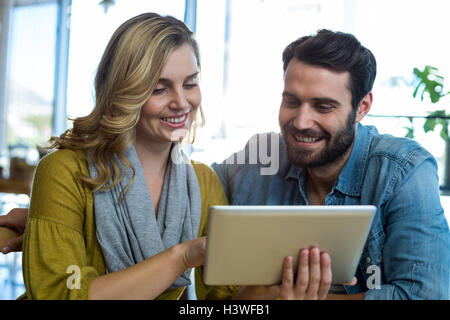 Couple using digital tablet in caf├⌐ Stock Photo