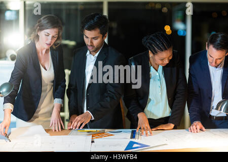 Group of businesspeople discussing over document Stock Photo