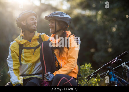 Biker couple sitting and interacting with each other Stock Photo