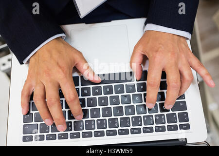 Technician using laptop Stock Photo