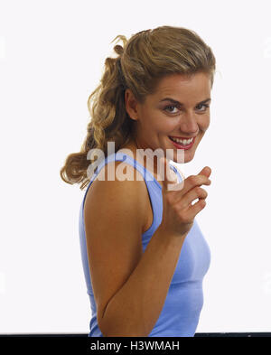 Woman, young, eyes, brown, hairs, blond, long, happy, gesture, half portrait, women, studio, cut out, long-haired, indicate, point, tip, show, view, camera, transmission, naturalness, Stock Photo