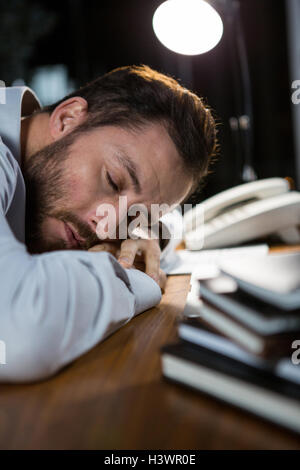 Tired businessman sleeping on the desk Stock Photo