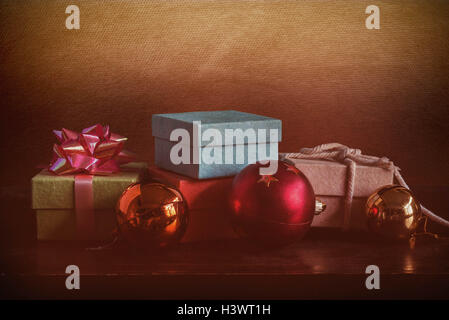 Gift boxes and colorful balls on the wooden floor. Stock Photo