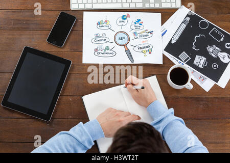 Man taking notes in diary Stock Photo