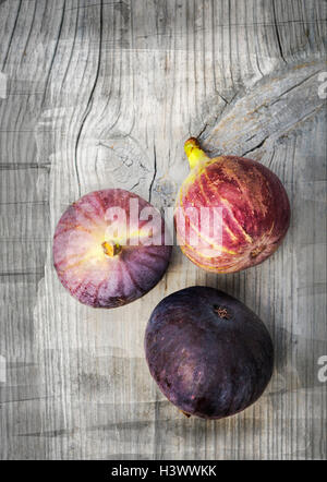 Image of three figs on vintage wood. Stock Photo