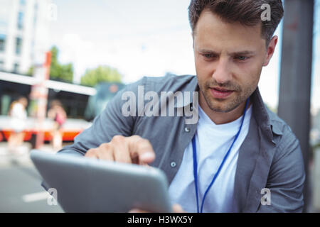 Handsome business executive using digital tablet Stock Photo