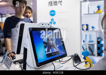 Hangzhou, China's Zhejiang Province. 12th Oct, 2016. A girl tries a payment system basing on face-recognition technology at the venue of 2016 Hangzhou YunQi Conference in Hangzhou, east China's Zhejiang Province, Oct. 12, 2016. This year's conference will start on Oct. 13 and last four days. © Xu Kangping/Xinhua/Alamy Live News Stock Photo