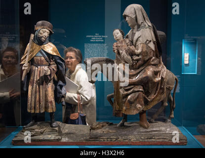 A woman stands in front of the artwork 'Flight to Egypt' from 1515 in the exhibition 'Holy Night - The Christmas story and its imagery' at Liebighaus in Frankfurt on the Main, Germany, 11 October 2016. The exhibition addresses the differential aspects of the Christian Christmas story. PHOTO: BORIS ROESSLER/dpa Stock Photo