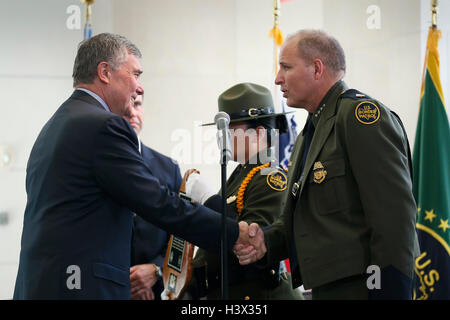 Washington DC, USA. 11th October, 2016. U.S. Customs and Border Protection Commissioner Gil Kerlikowske, left, congratulates newly appointed Chief of Border Patrol Mark Morgan during a ceremony at the Ronald Reagan Building October 11, 2016 in Washington, D.C. Credit:  Planetpix/Alamy Live News Stock Photo