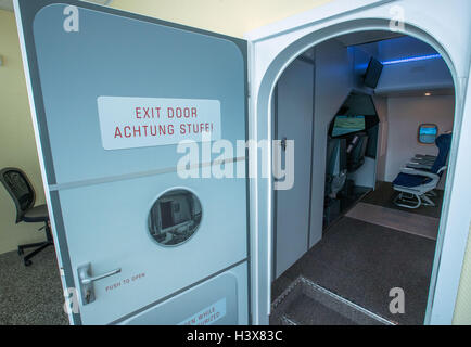 Rostock, Germany. 12th Oct, 2016. The door opens onto the self-built flight simulator in Rostock, Germany, 12 October 2016. Over recent months, computer specialists from the MV-IT-Systeme project have built a faithful reproduction of a Boeing 737-800 cockpit, as well as part of the cabin with 15 seats. Using the simulator, which officially opens on 19 October 2016, takeoffs and landings can be practised at more than 20,000 simulated airports around the world. PHOTO: JENS BUETTNER/DPA/Alamy Live News Stock Photo