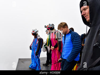 Zhangjiajie, China's Hunan Province. 13th Oct, 2016. Ellen Brennan (1st L) of the United States checks the route before the qualification of World Wingsuit League (WWL) China Grand Prix 2016 in Zhangjiajie, central China's Hunan Province, Oct. 13, 2016. Ellen Brennan is the only female wingsuit flier of this competition, who has completed over 750 wingsuit flyings. Credit:  Liu Dawei/Xinhua/Alamy Live News Stock Photo