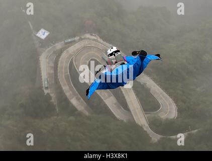 Zhangjiajie, China's Hunan Province. 13th Oct, 2016. Ellen Brennan of the United States glides during the qualification of World Wingsuit League (WWL) China Grand Prix 2016 in Zhangjiajie, central China's Hunan Province, Oct. 13, 2016. Ellen Brennan is the only female wingsuit flier of this competition, who has completed over 750 wingsuit flyings. Credit:  Liu Dawei/Xinhua/Alamy Live News Stock Photo