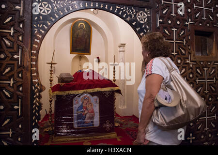 Assiut, Egypt. 11th Oct, 2016. A woman visits the cubic-shaped altar inside Virgin Mary's Church of Al-Muharraq Monastery, where Jesus stayed for six months and five days, in Assiut, Egypt, Oct. 11, 2016. The Monastery of Virgin Mary at Al-Muharraq and the Convent of Virgin Mary on the Mountain of Assiut province in southern Egypt stand as historical eyewitnesses of the flee trip of the Holy Family of Jesus Christ, his mother Virgin Mary and St. Joseph to Upper Egypt over 2,000 years ago. © Meng Tao/Xinhua/Alamy Live News Stock Photo