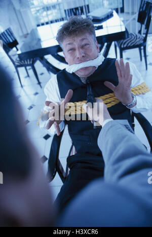 Businessman, tied up, gagged, man, weapon, threat, crimes, extortion, taking of hostages, icon, oppressive contract, criminal activity, danger, fear, caught, hostage, kidnapper, gun, aim Stock Photo