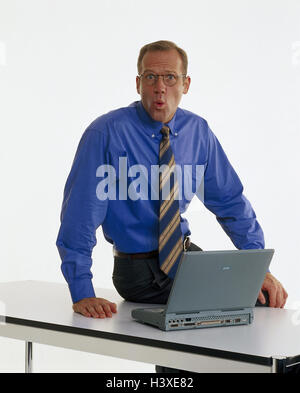 Businessman, young, laptop, facial play, is surprised, table, sit, professions, studio, cut out, notebook computer, astonishment, astonished, Stock Photo