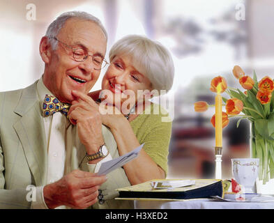 Senior couple, sit, at photo album, look, smile, happy, recollections Senior, inside, at home, pictures, photos, album, recollection, nicely, positively, remind, luck, past, senior citizens, couple, man, woman, senior, senior, old, Stock Photo