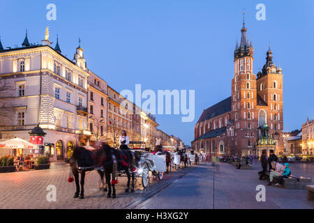 Krakow - Poland - April 22. Krakow - evening picture of old square in Krakow. People walking through the square. Stock Photo