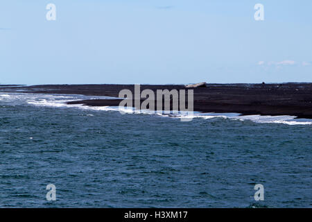 waves breaking on volcanic black sand beach bakki southern Iceland Stock Photo