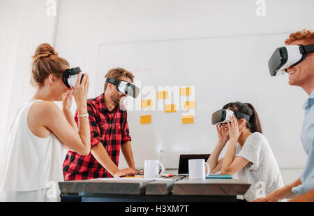 Team of developers working with virtual reality glasses during a business meeting. Young business colleagues brainstorming using Stock Photo