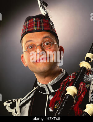Scot, young, glasses, earring, bagpipes, facial play, portrait, concepts, Scotland, man, musical instrument, clothes, headgear, tradition, checked, smile, grin, smile, astonished, studio, Stock Photo