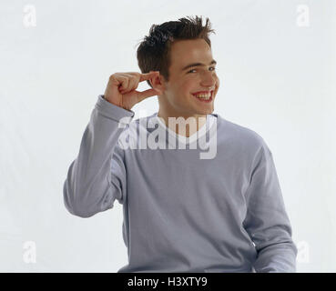 Young person, pullovers, grey, laugh, interpret gesture, finger, dimensional information, small, half portrait, Teens, teenager, boy, man, young, point, indicate, size, mood, happy, cheerfully, positively, studio, cut outs, Stock Photo