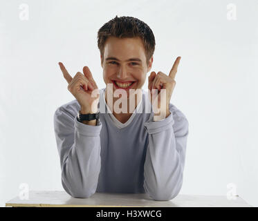Young person, sit, pullovers, grey, laugh, interpret gesture, hands, forefingers, half portrait, Teens, teenager, boy, man, young, point, finger, body language, tip, mood, happy, cheerfully, positively, studio, cut outs, Stock Photo